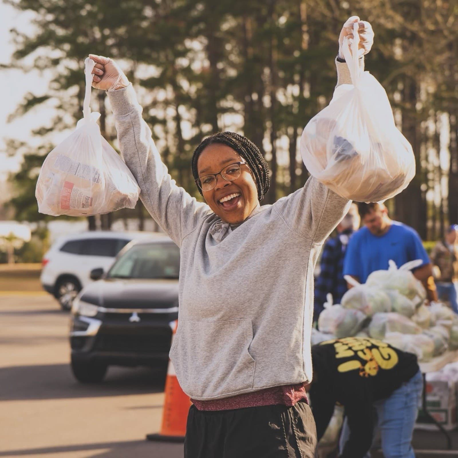Volunteer carrying grocery bags at Impact Center