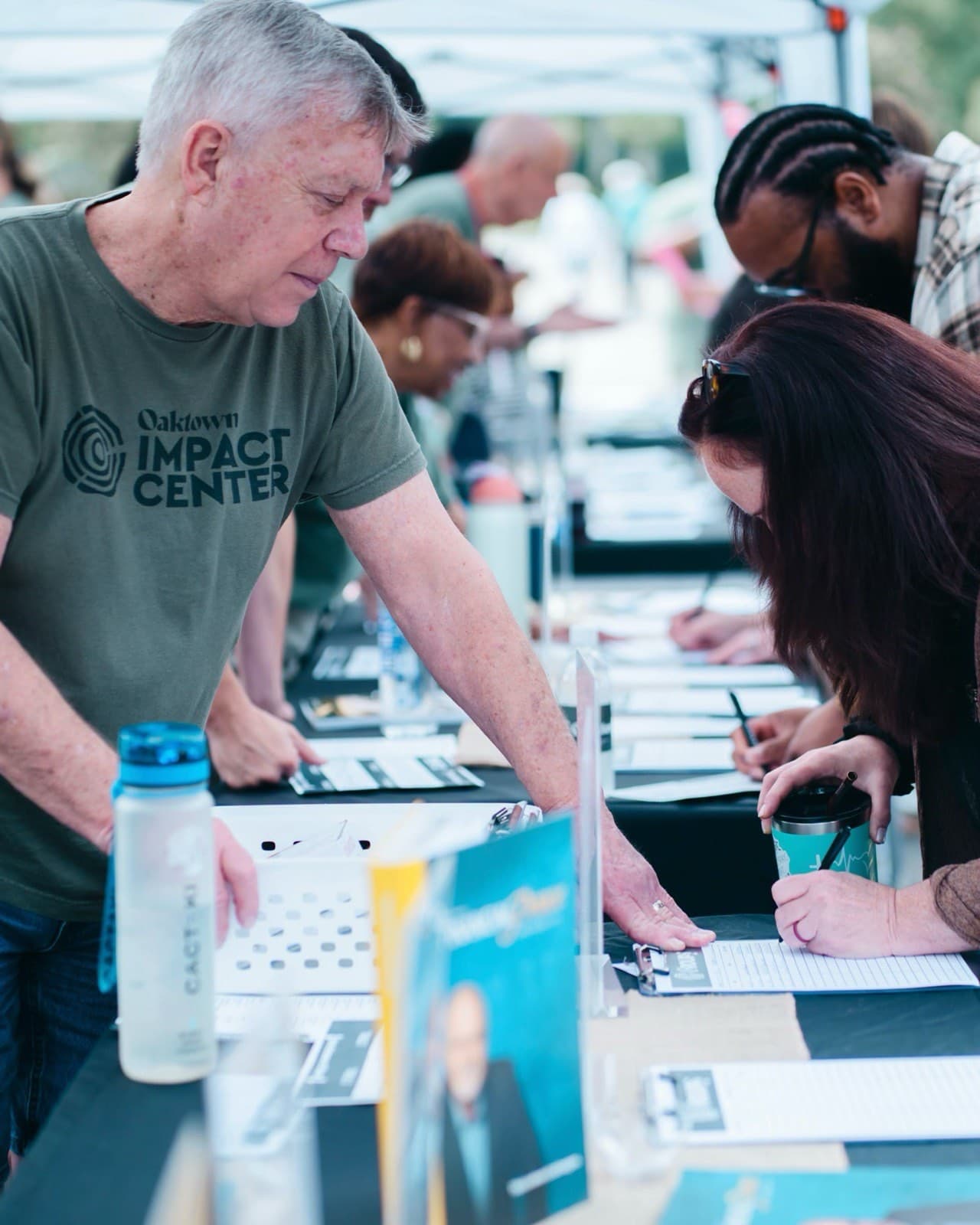 Impact Center volunteer helping with sign-in